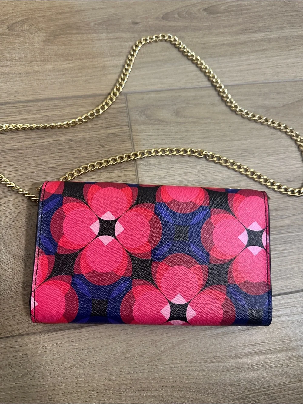 Trina Turk pink, red, black and blue cross body clutch with gold tone chain